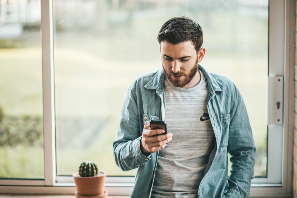 Man Causally looking at phone